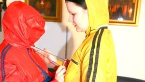 Jill and a friend of her pplaying with eachother wearing yellow and red shiny nylon rainwear (Pics)