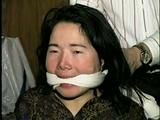 25 YEAR OLD ASIAN MAI-LING IS MOUTH STUFFED, CLEAVE GAGGED, HANDGAGGED, OTM GAGGED, TAPE GAGGED & TIGHTLY TIED TO A CHAIR  (D47-15)