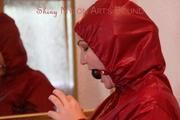 Jill ties, gagges and hoodes herself in front of a mirror and in an strairway wearing a sexy shiny nylon rain pants in black and a red rain jacket (Pics)