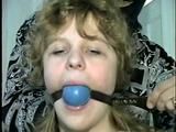 19 Yr OLD SINGLE MOM RONI IS WRAP CLEAVE GAGGED WITH AN ACE BANDAGE, HANDGAGGED, MOUTH STUFFED, BALL-GAGGED & TIED BACKWARDS TO A CHAIR (D53-9)