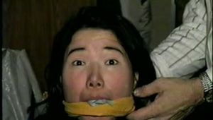 25 YEAR OLD ASIAN MAI-LING IS MOUTH STUFFED, CLEAVE GAGGED, HANDGAGGED, OTM GAGGED, TAPE GAGGED & TIGHTLY TIED TO A CHAIR  (D47-15)