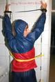 Stella tied, gagged and hooded on an radiator wearing a shiny red/blue rain combination (Pics)