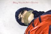 Shelly tied and gagged in shiny nylon rainwear