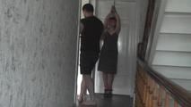 Kim tied to the door
