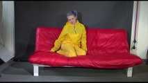 Watching Mara putting on sexy yellow shiny nylon rainwear lolling on the sofa (Video)