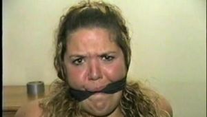 BBW MICHELLE'S IS MOUTH STUFFED, VET TAPE WRAP CLEAVE GAGGED, CHAIR TIED, BAREFOOT & WEARING A SATIN BLUE SLIP (D59-4)