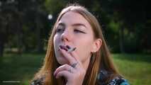 Sweet Svetlana is smoking two all white cigarettes