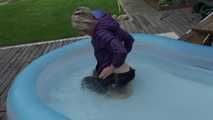 Watching sexy Sonja wearing a sexy shiny nylon rain pant and a purple down jacket enjoying the water in the swimming pool (Video)
